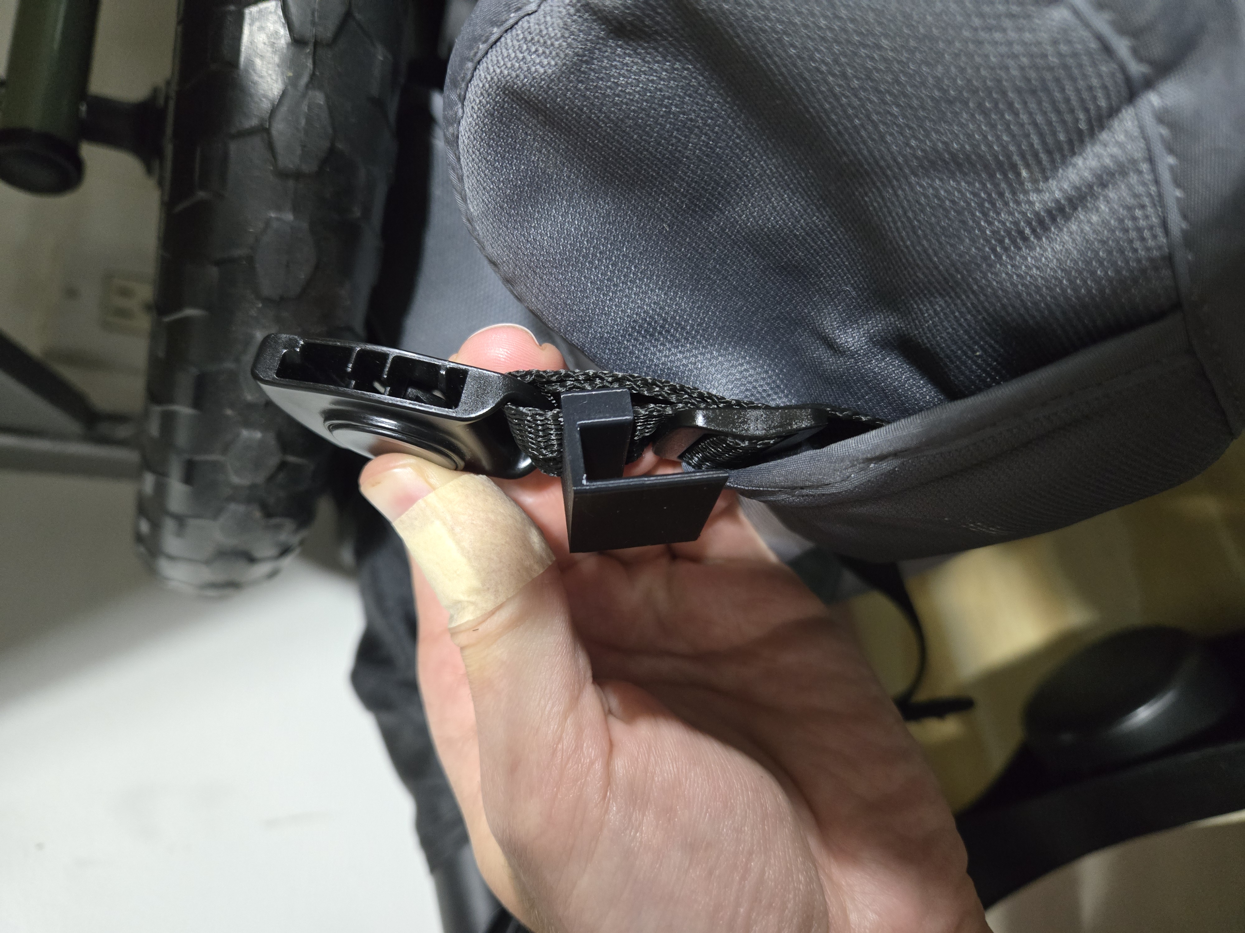 Stroller pad retainer