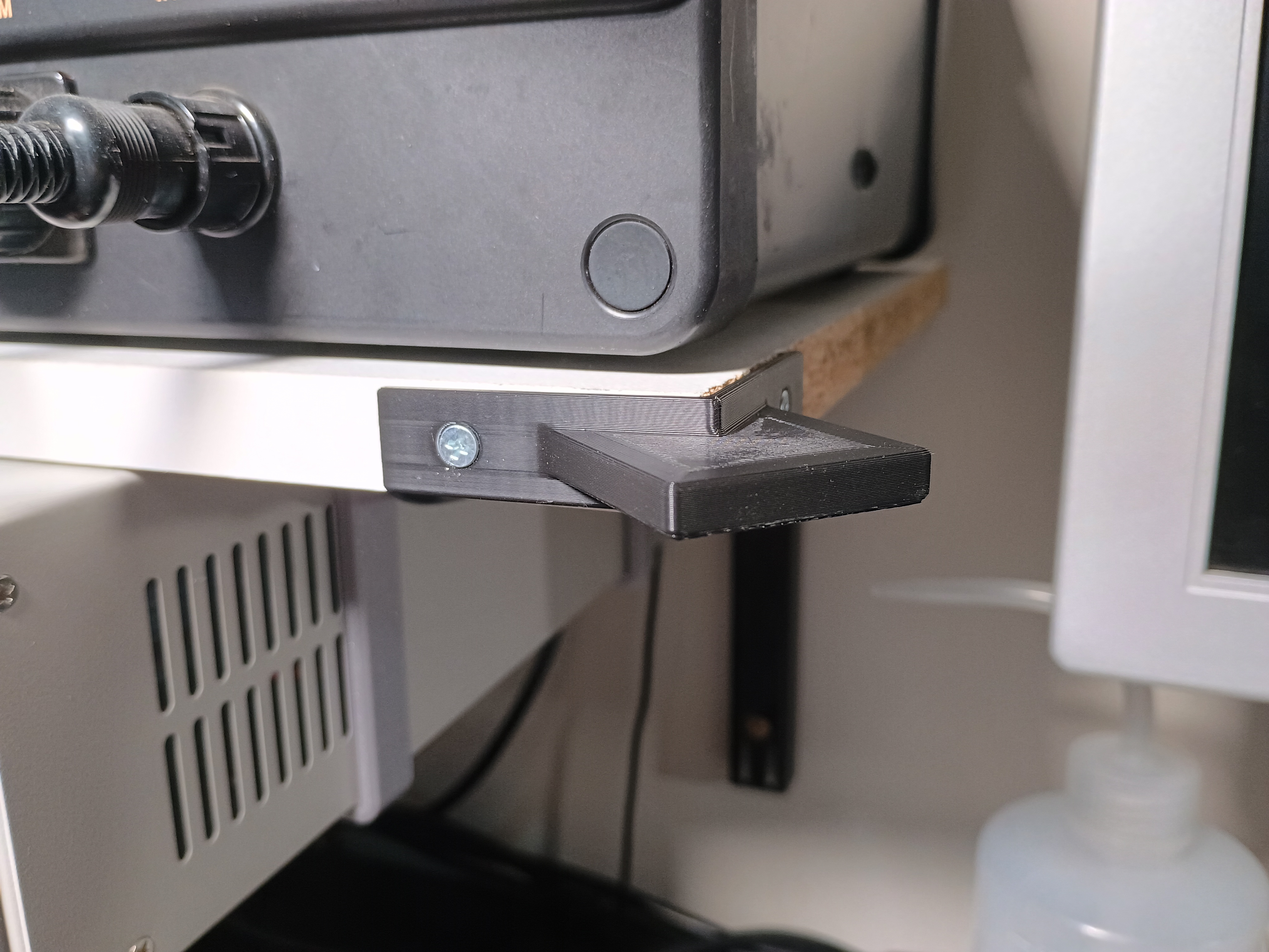 Hanger for Brymen BM235 EEVBlog Multimeter on the corner of a shelf for easy viewing
