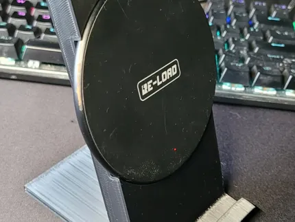 Phone stand with a slot for a round wireless charger (100 mm diameter).
