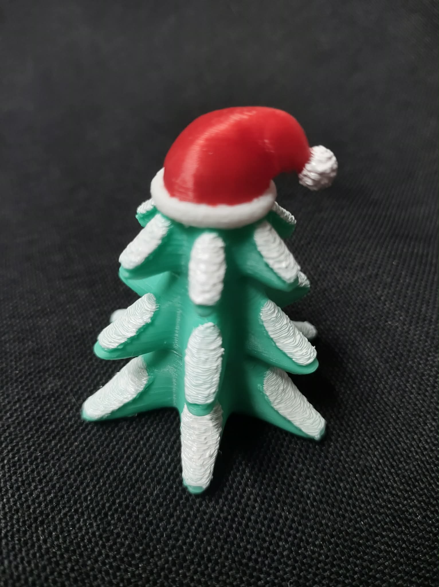Snowy Christmas Tree wearing Santa's Hat Figurine