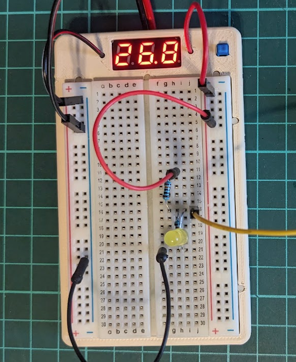 Breadboard holder with holes for voltmeter and switch