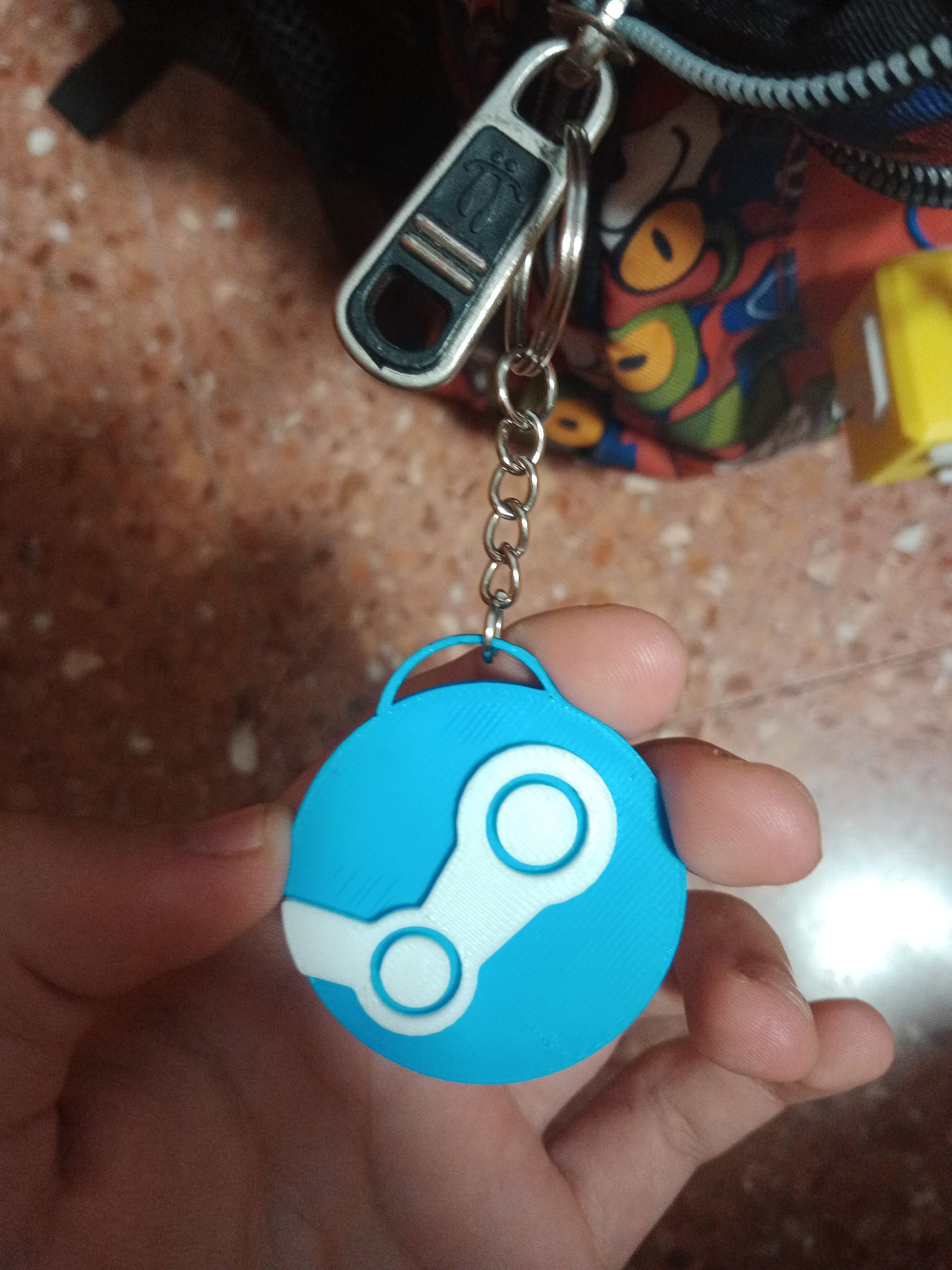 Llavero del logo de "Steam".