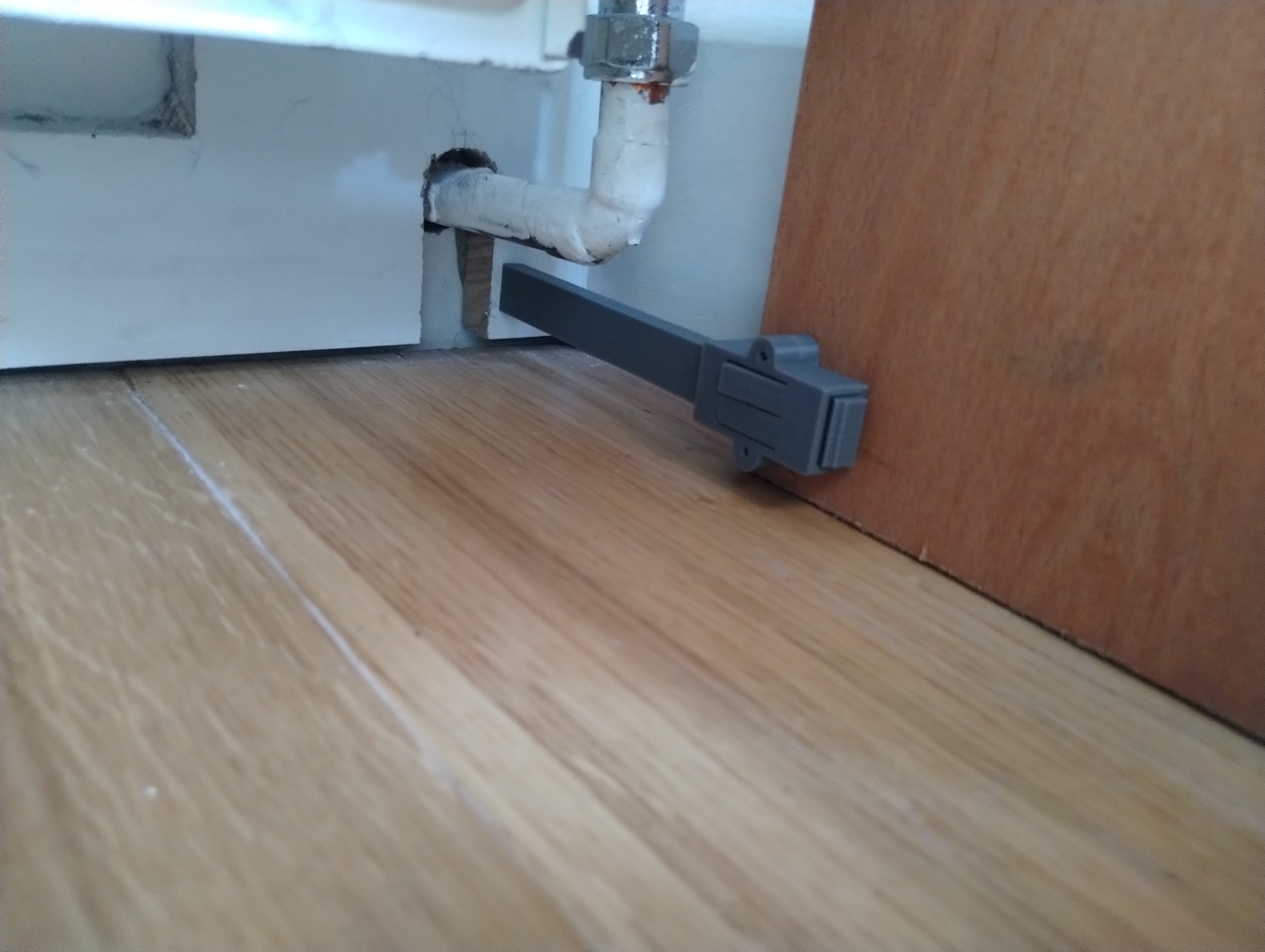 Adjustable ratcheting furniture wall stay foot