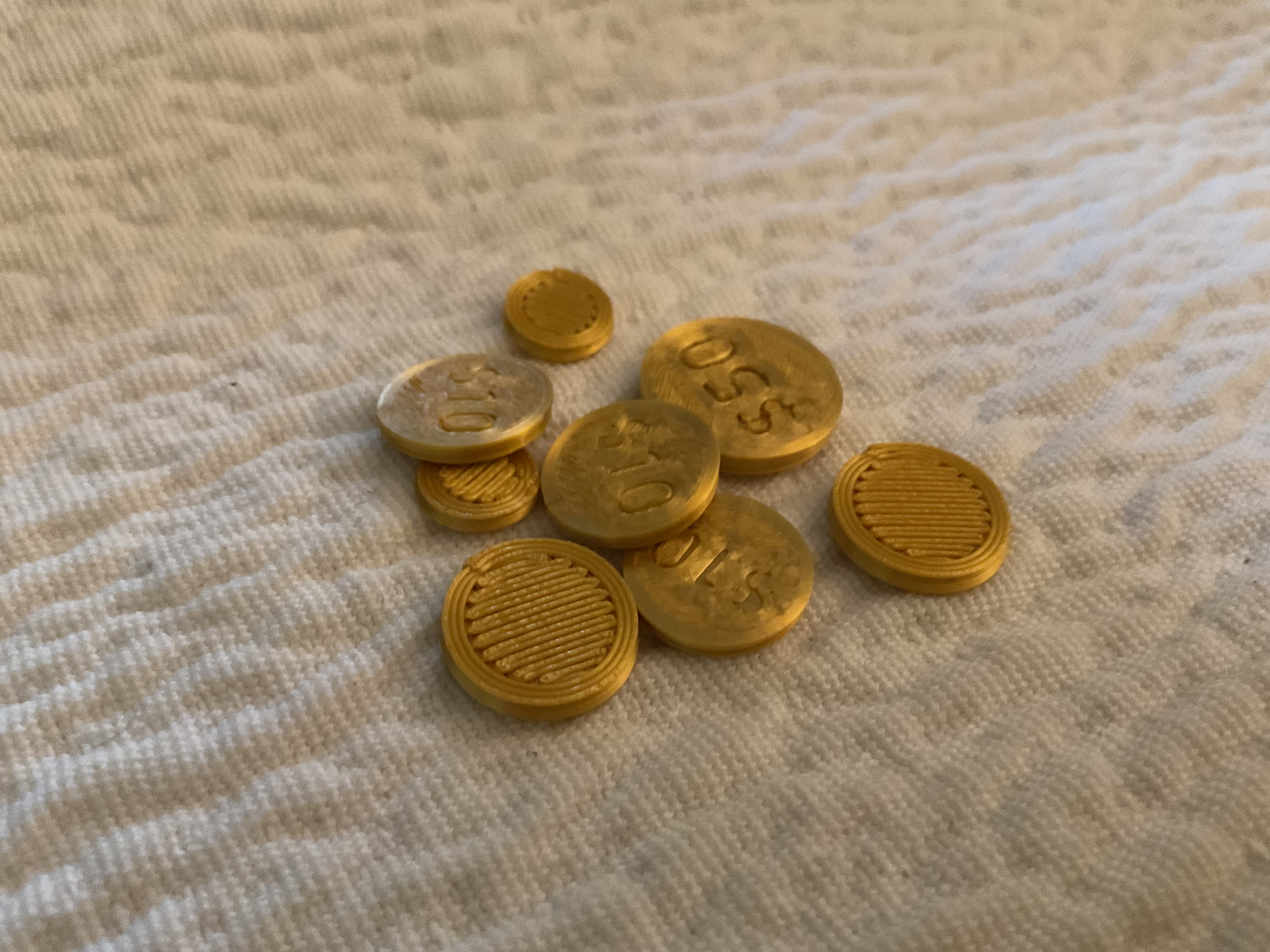 Set of coins: 1, 5, 10, 50 (Good as props or for board games)