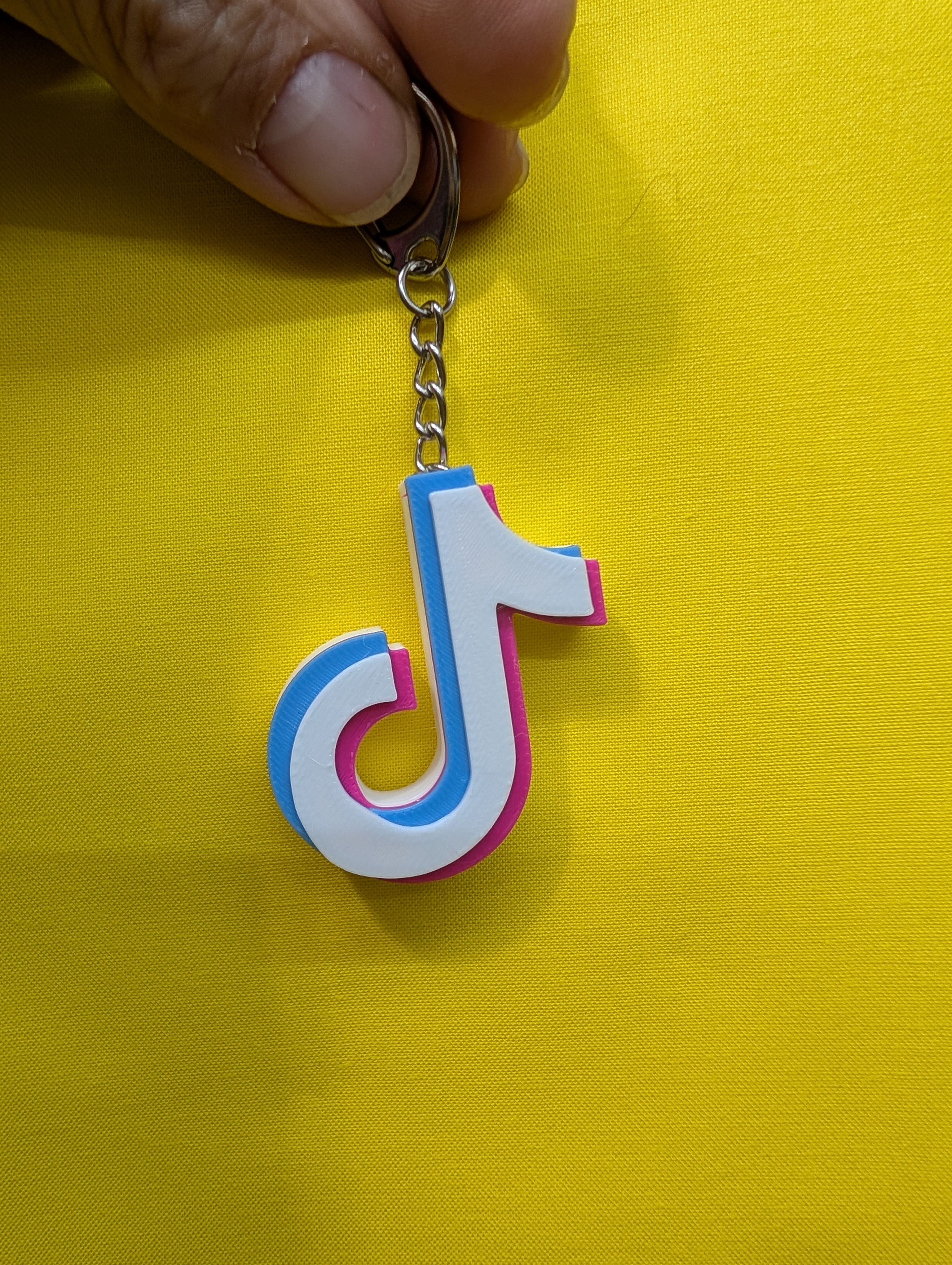 TikTok keychain with chain inserted into the model during print