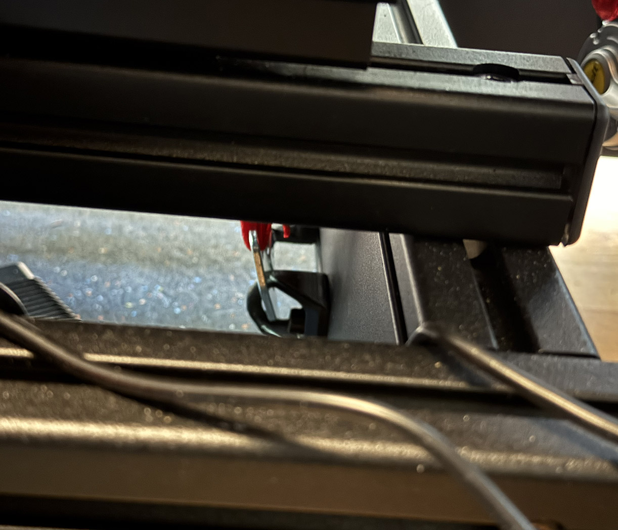 Sim racing belt tensioner rig latches for groin area
