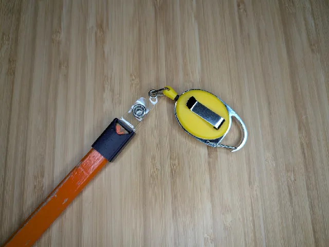 Carpenter pencil holder with loop for a retractable badge