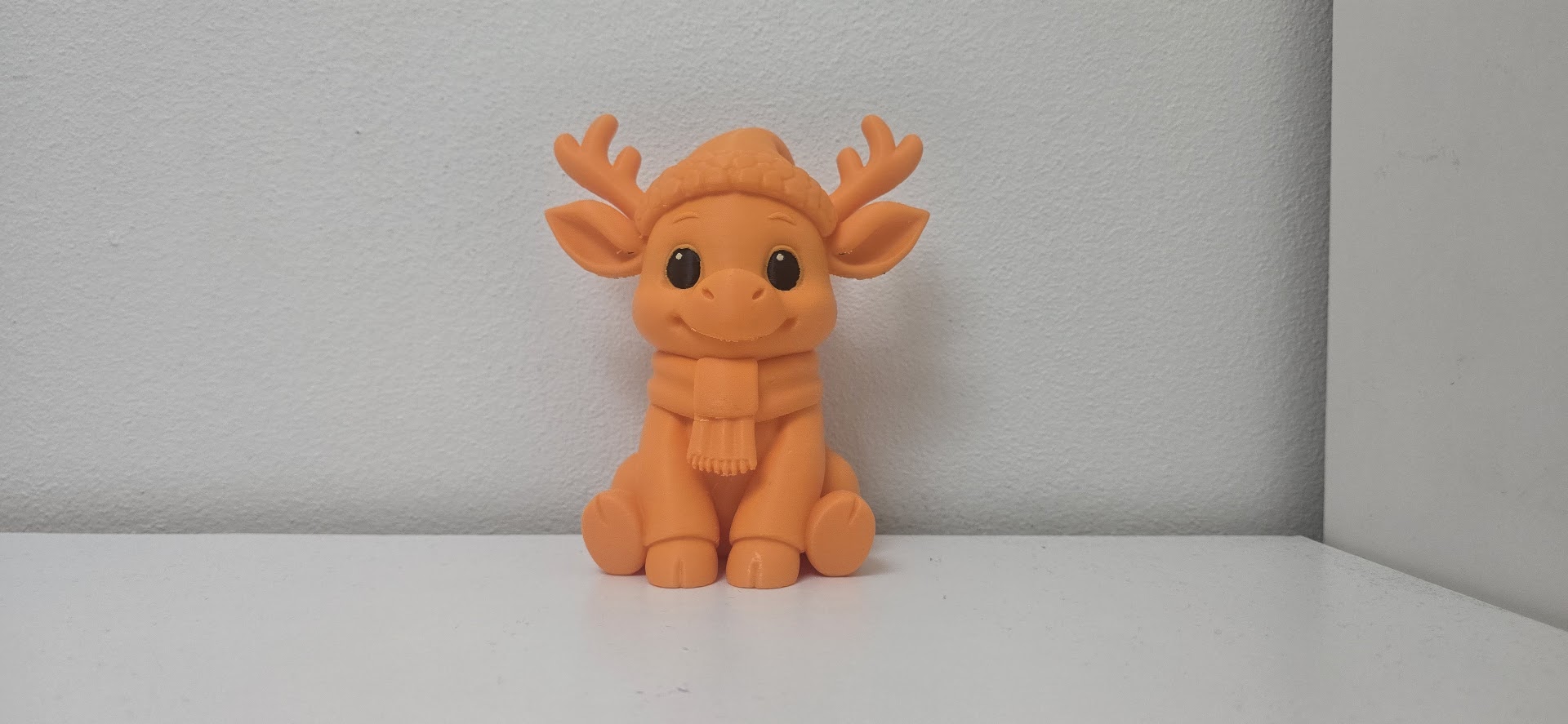 Reindeer in Hat and Scarf Christmas Figurine