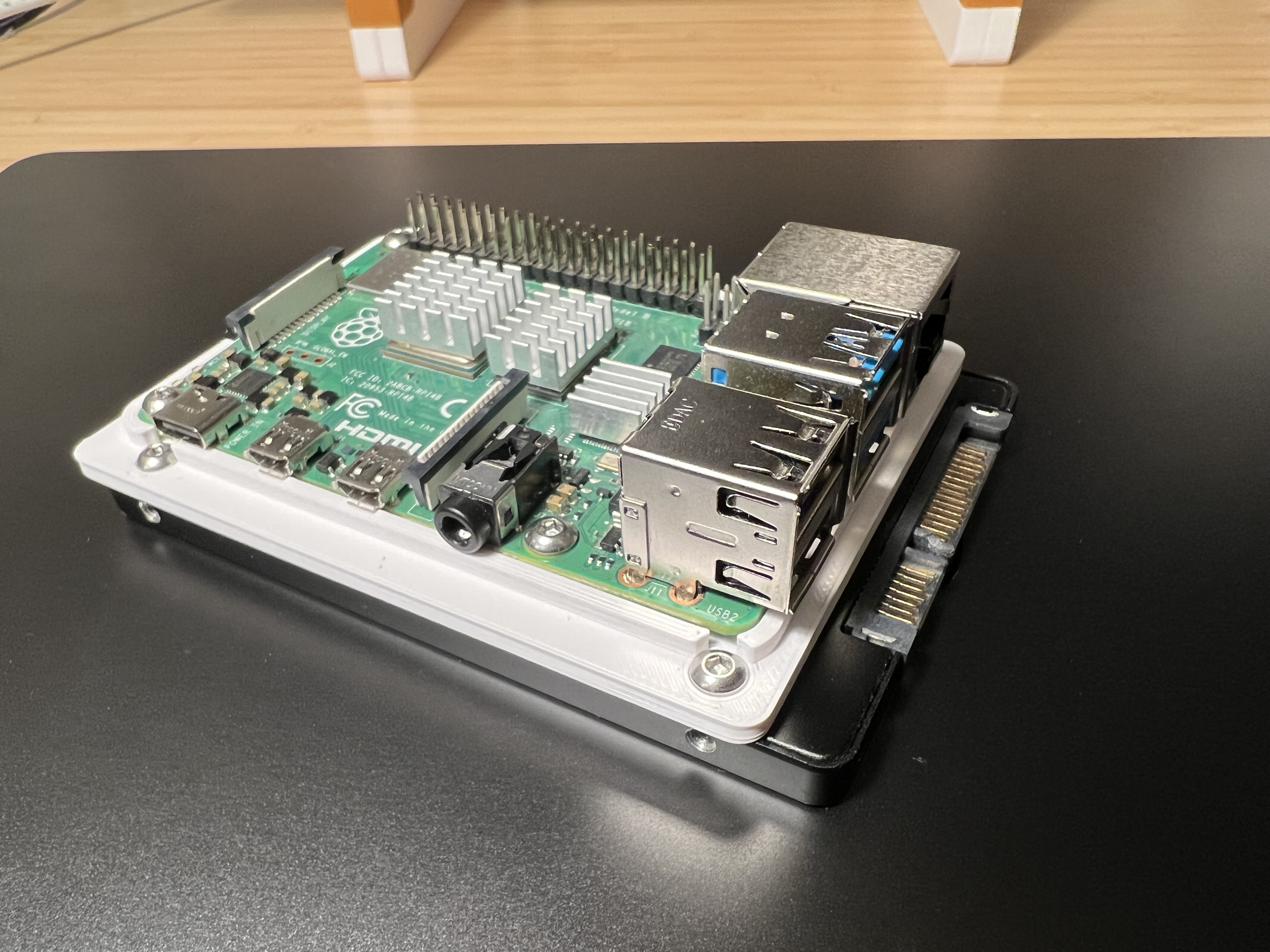 Raspberry Pi single‑board computer with a 2.5" SATA SSD in a single compact stack