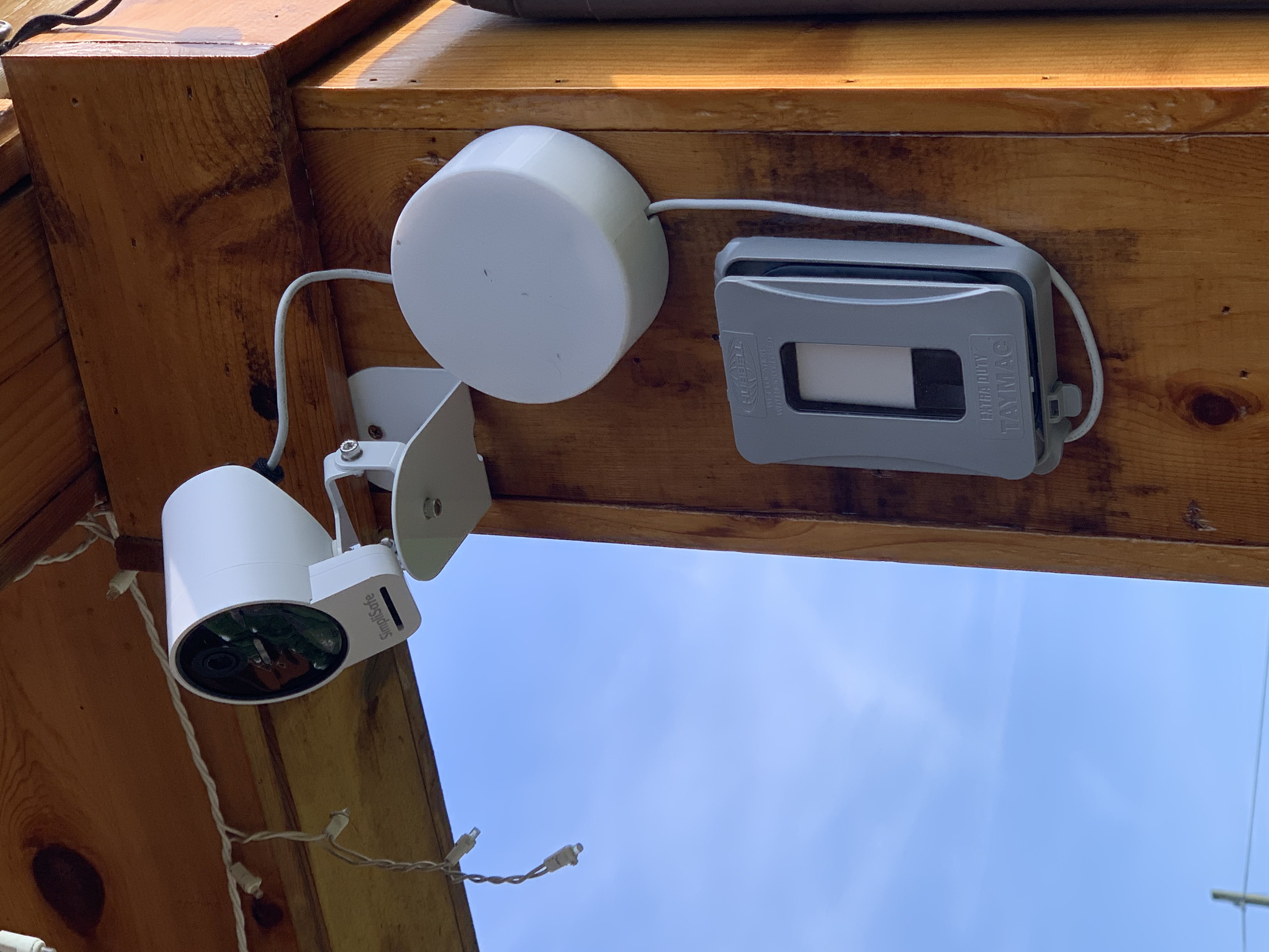 Exterior camera power cord holder