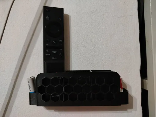 Wall Mounted Remote Holder With Honeycomb Pattern and AAA battery slots
