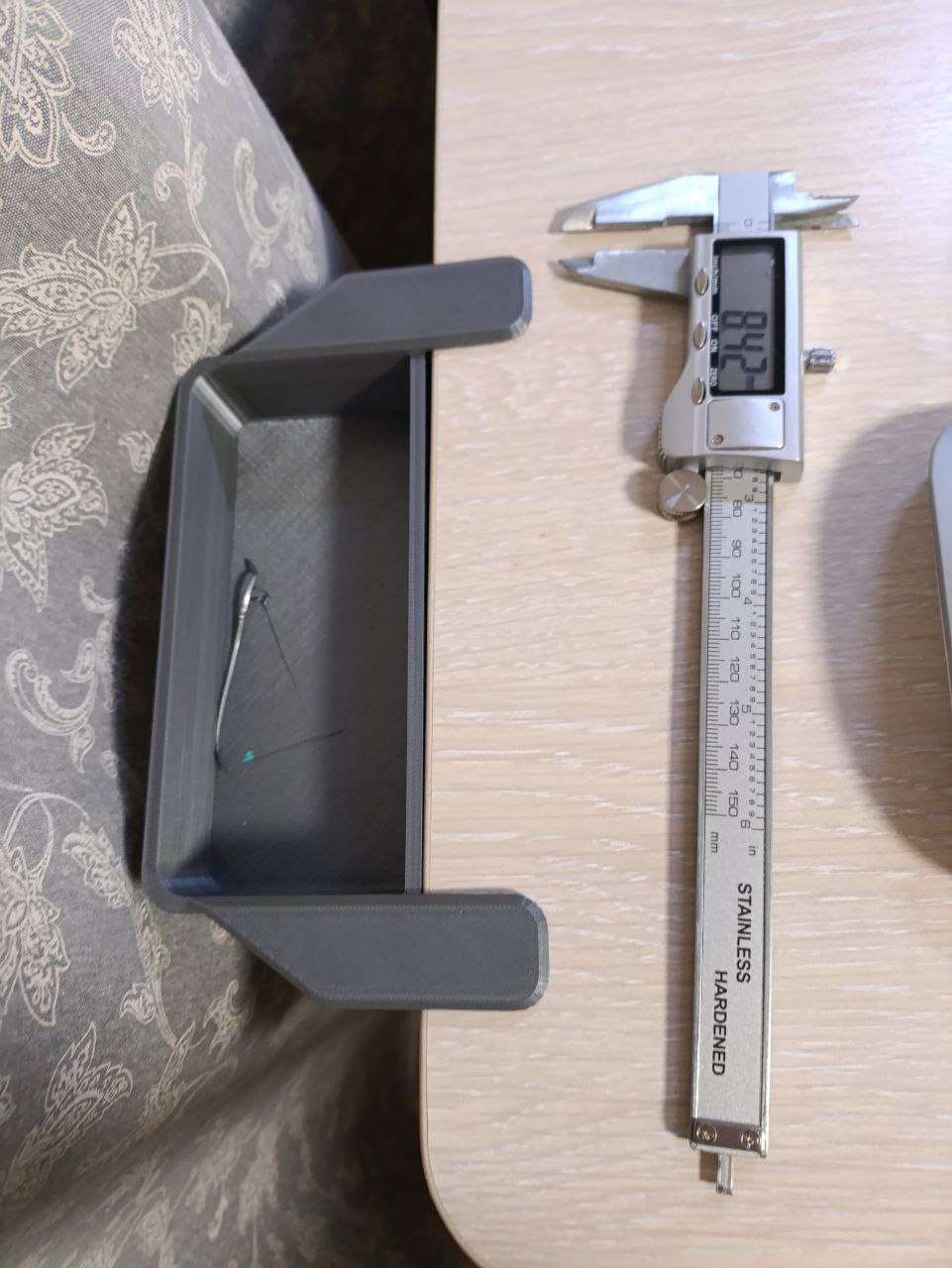 А trash container with a table mount.