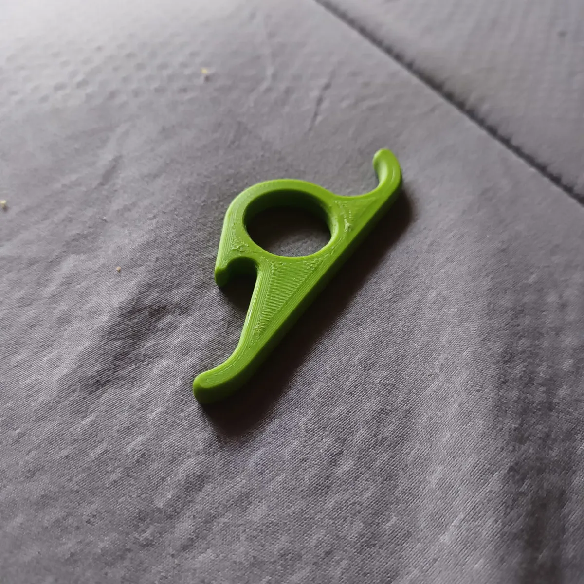Release aid for archery - To use: the reverse of a traditional trigger release. You point your index finger forwards to release. I use it on my 70lb compound bow so the model can handle the force 