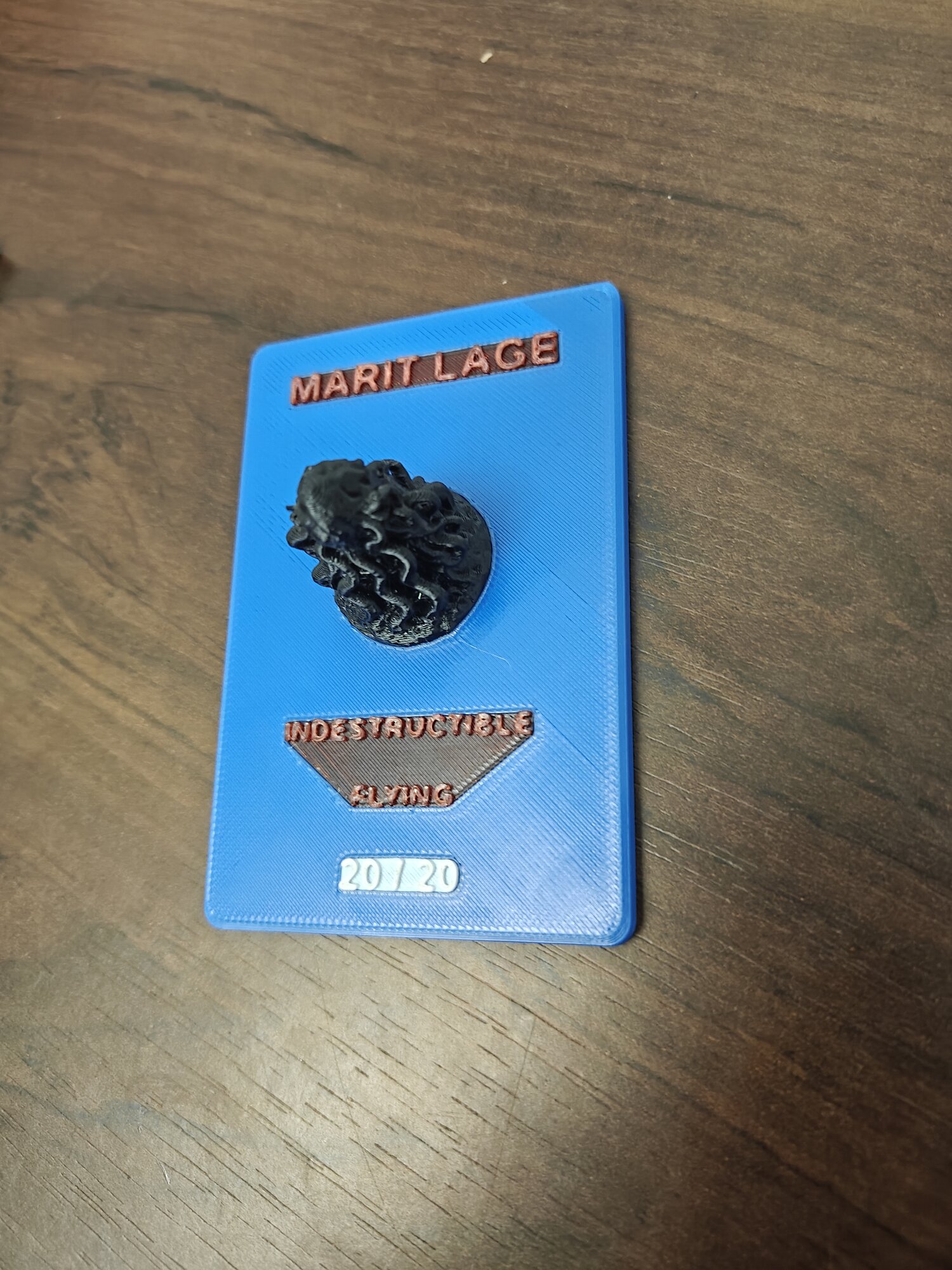Marit Lage 20/20 Token — MTG flat-card display plinth with eldritch sculpt + multicolour text