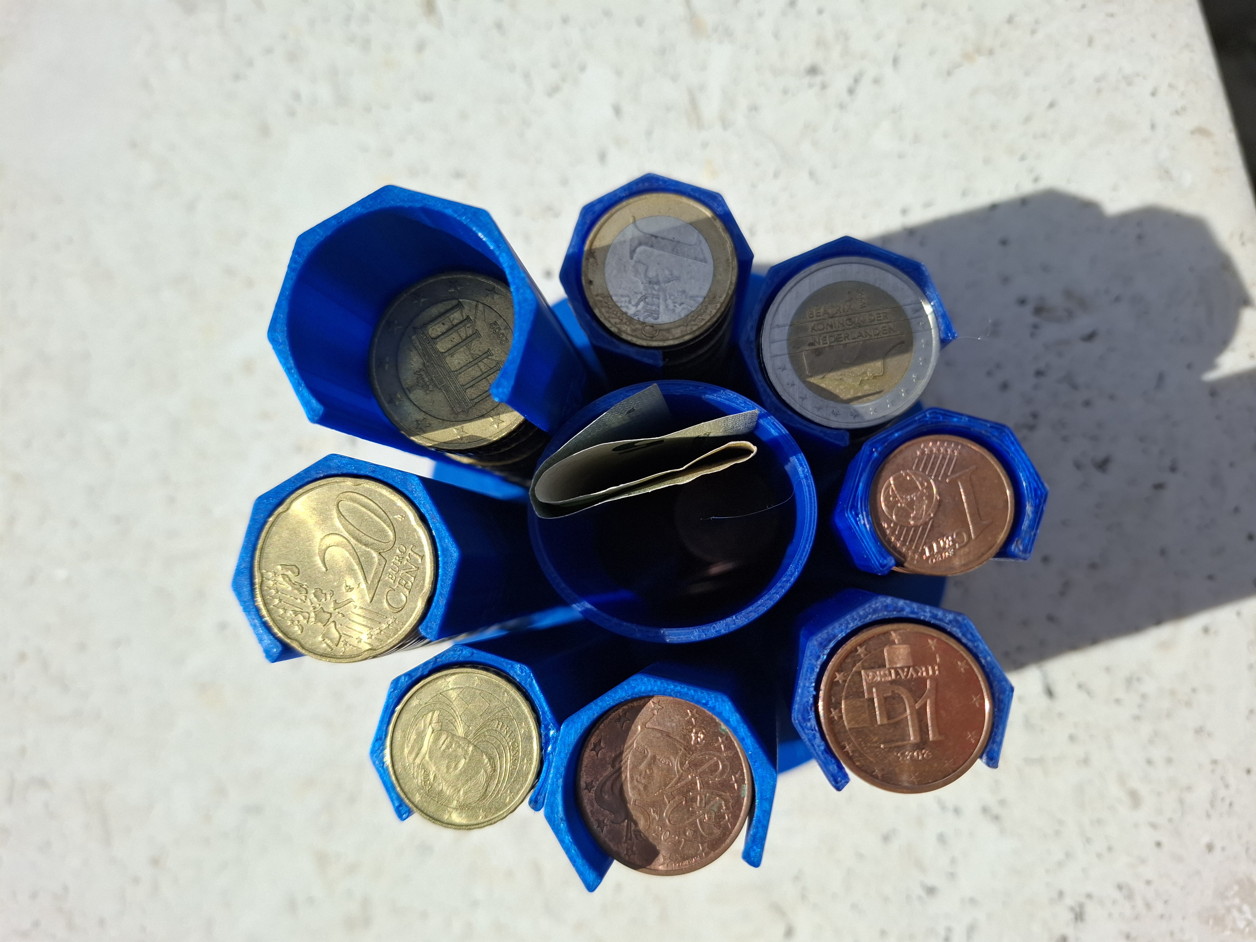 "Free"-Euro-Coin-Pillars with base corresponding to "bank role paper", tagged