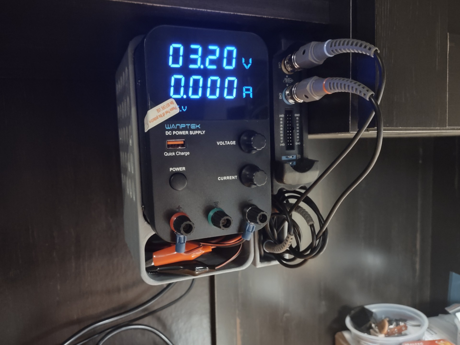 Under cabinet mounting bracket and cable caddy for a Wanptek GPS3050 power supply