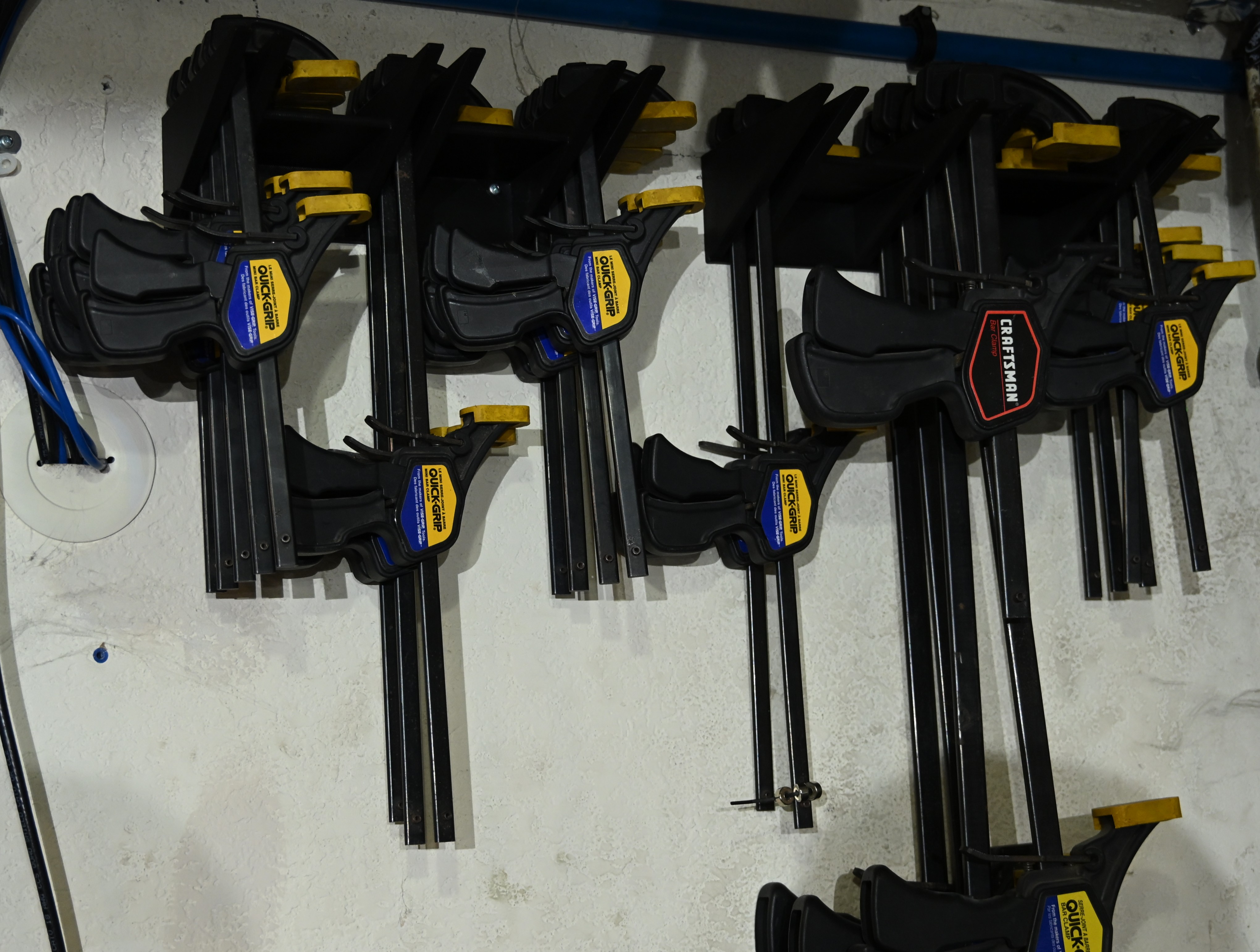 Quick-Grip bar clamp racks, space efficient flat-on-wall storage