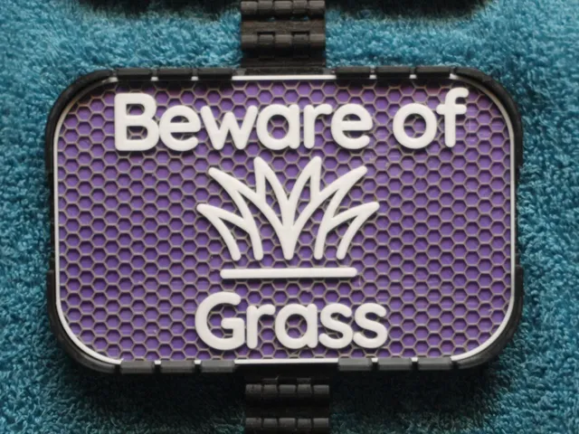 Beware of Grass sign